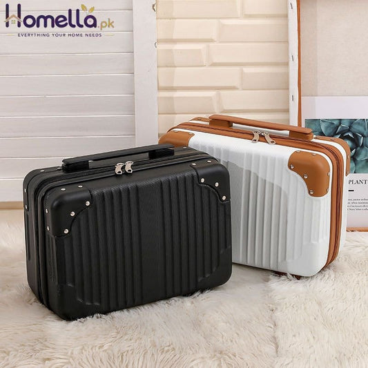Black and white suitcases with brown handle on a light wooden floor.
