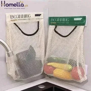 Two mesh produce bags labeled 'Beginning' with fruits and vegetables inside, hanging on a kitchen sink.