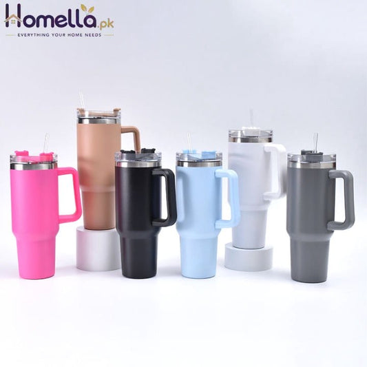 Set of insulated travel mugs with handles in various colors on a light gray background
