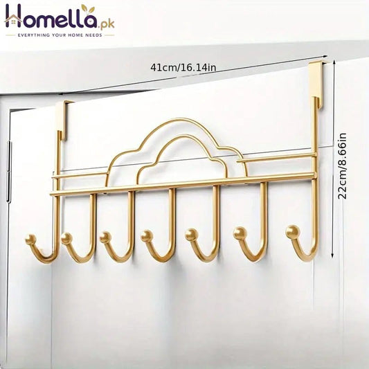 Gold over-the-door hook rack with measurements on a white door background