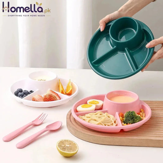 Two divided plates, one green and one pink, with food and cutlery on a white surface.