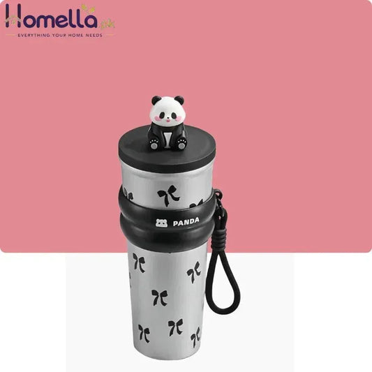 White tumbler with black panda design and panda-shaped lid on a pink background