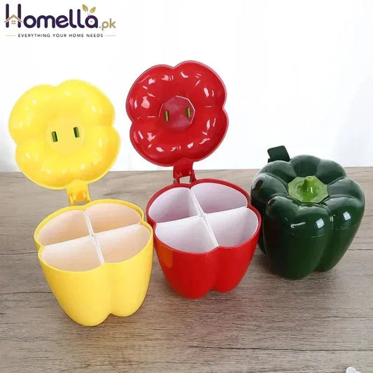 Colorful container shaped like a yellow flower, red bell pepper, and green bell pepper on a wooden surface.