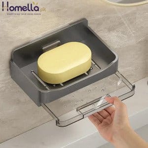 Gray soap holder with a bar of soap on a bathroom counter.