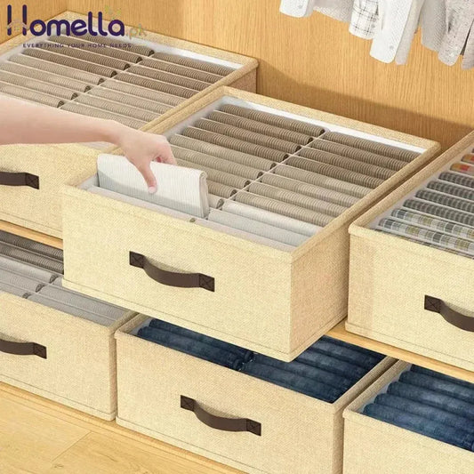 Stack of beige storage drawers with brown handles on a wooden floor.