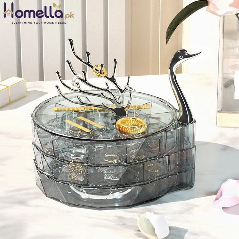 Jewelry organizer with a swan design on a table