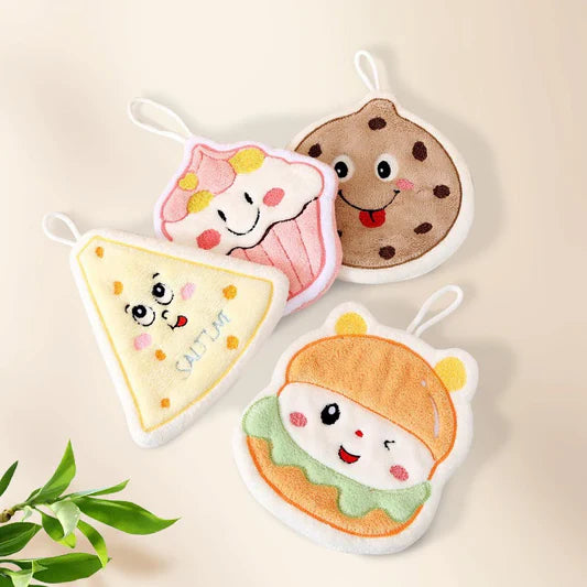 Four cute plush toys shaped like a slice of pizza, cupcake, cookie, and hamburger on a beige background.