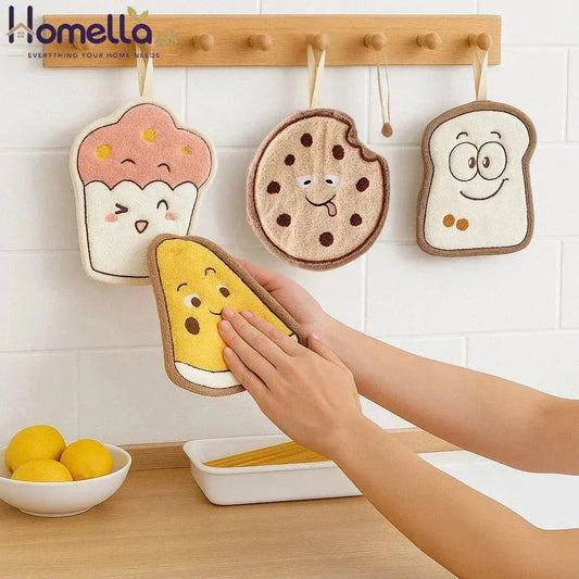 Four cartoon-themed pot holders hanging on a wooden rack with a hand reaching for one of them.