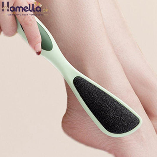 Person using a green and black foot scrubber on their leg.