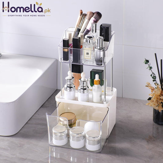 Clear acrylic cosmetic organizer with various items on a bathroom counter.