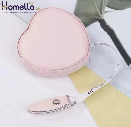Pink heart-shaped case with a matching nail clipper on a light background