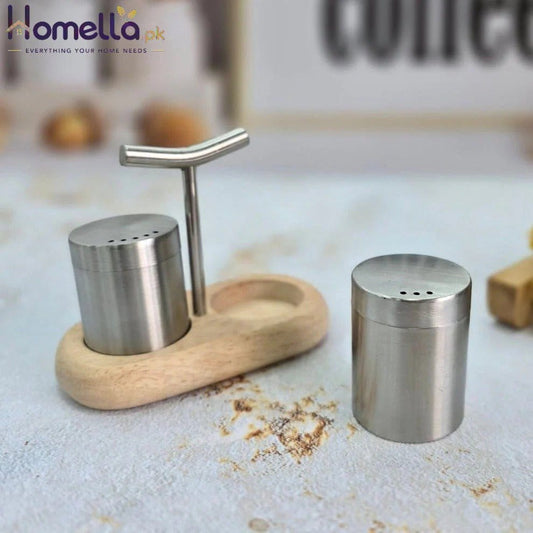 Stainless steel shakers with wooden stand on a kitchen counter