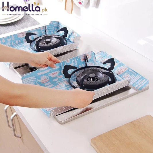 Person placing a portable gas stove on a blue mat with cartoon designs.
