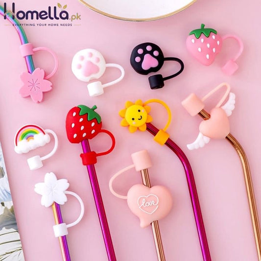 Various colorful straw tips with cartoon designs on a pink background