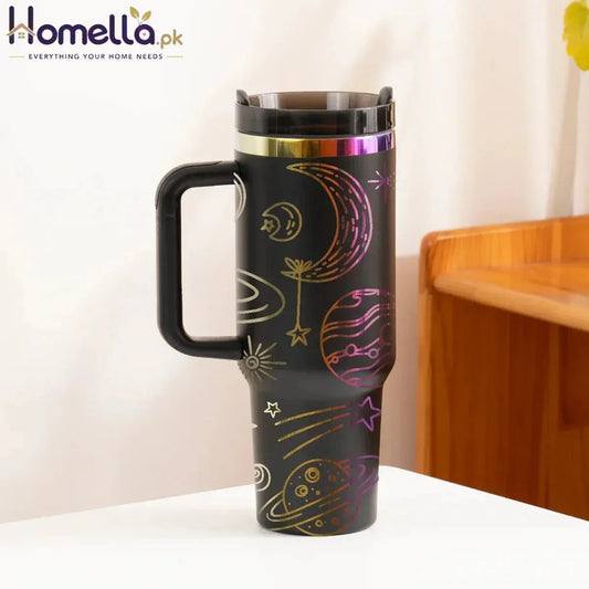 Travel mug with space-themed design on a white surface